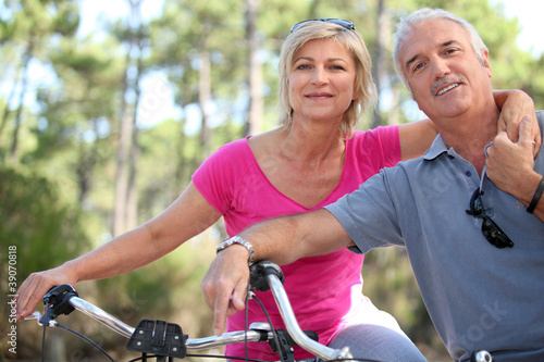 portrait of mature couple on bicycle