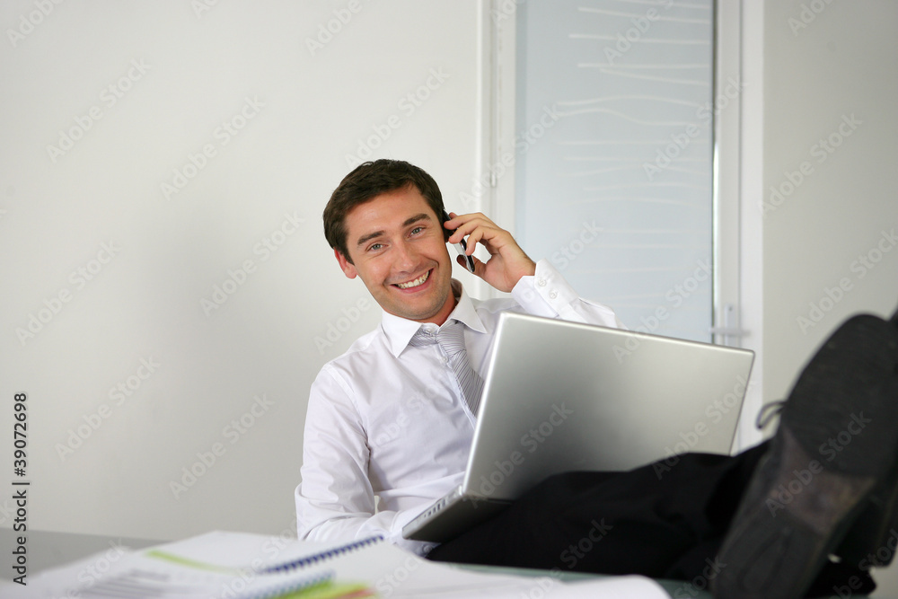 Businessman sat with his feet on the desk Businessman sat with his feet on the desk