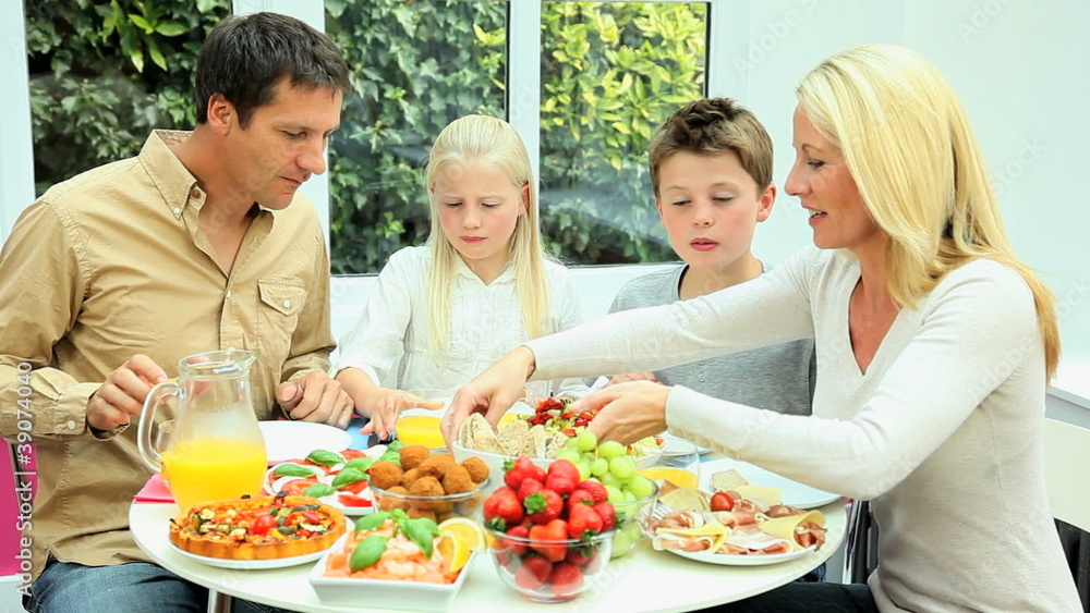 Young Caucasian Family Eating Healthy Lunch Together Young Caucasian Family Eating Healthy Lunch Together