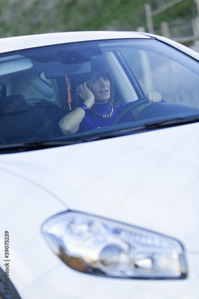 Woman driving holding a cellphone