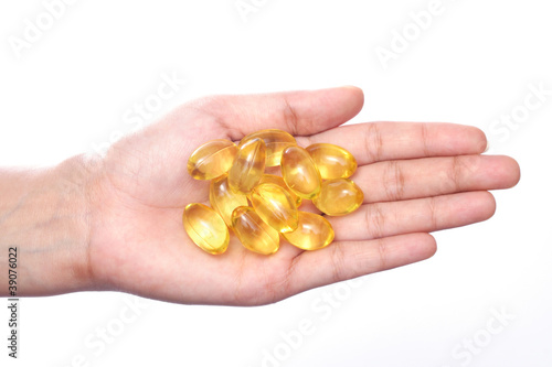 Cod liver oil pills in hand