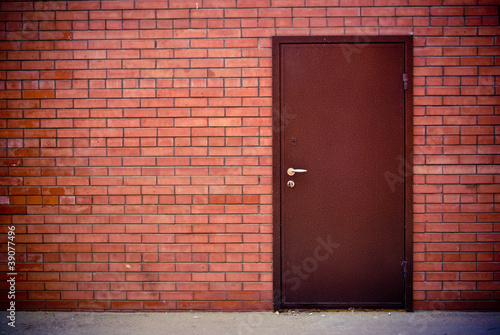 Red brick wall and the iron closed door