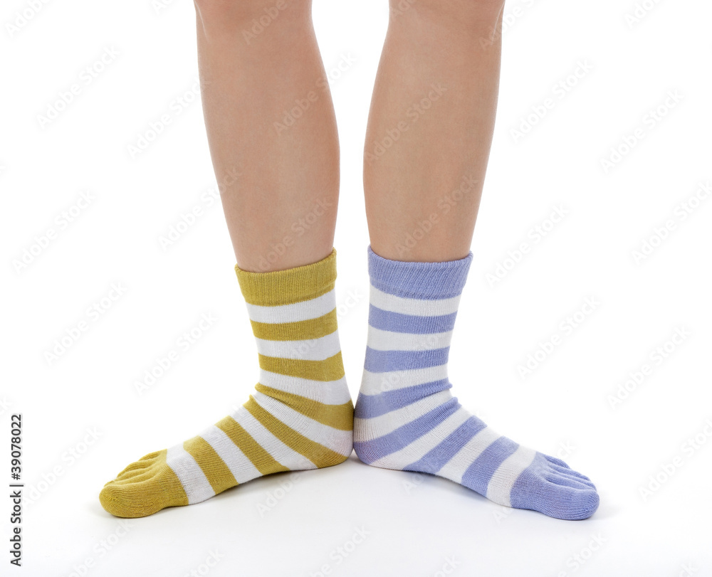 Funny legs in socks of different colors Stock Photo | Adobe Stock