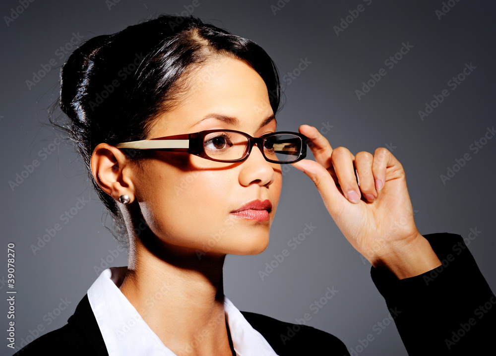 Young professional touching her glasses Young professional touching her glasses