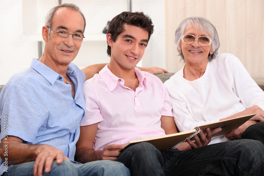 grandparents and grandson skimming through album grandparents and grandson skimming through album