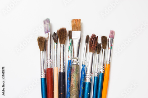 Set of old paint brushes on a white background.