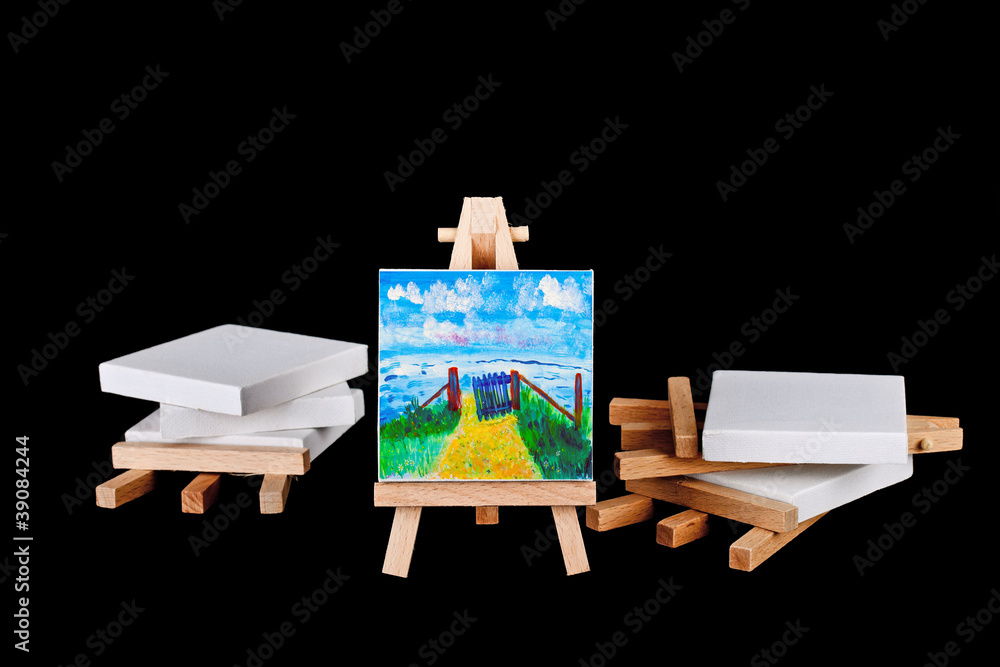 Naklejka premium Artists easels stacked on a black background