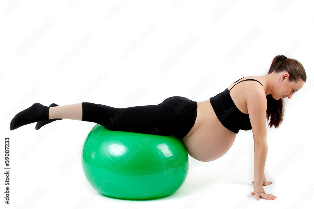 Pregnant woman excercises with gymnastic ball. Beautiful pregnan Pregnant woman excercises with gymnastic ball. Beautiful pregnan
