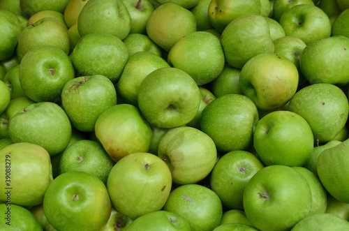 close up of green apples on market stand