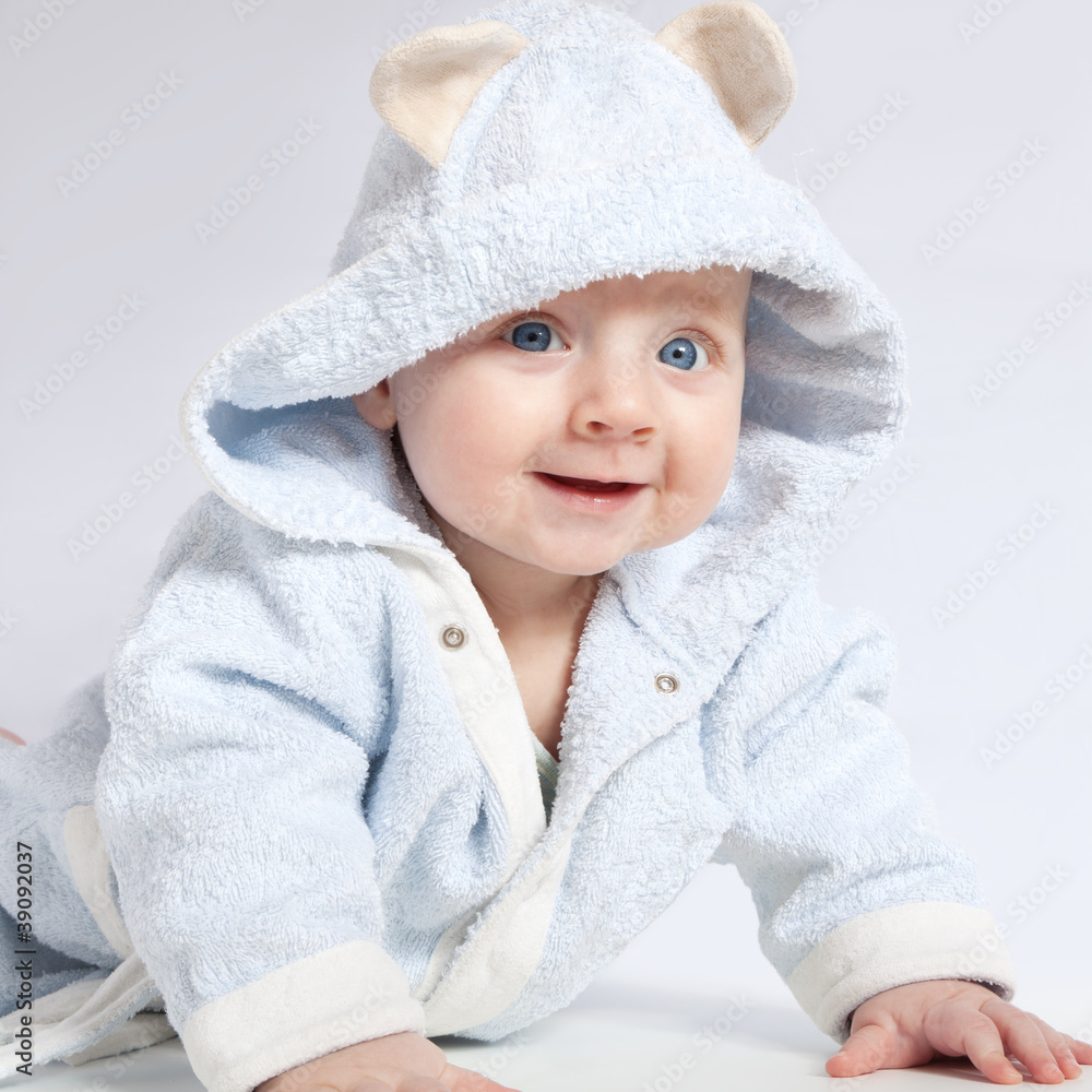 portrait of a cheerful child in blue bathrobe portrait of a cheerful child in blue bathrobe
