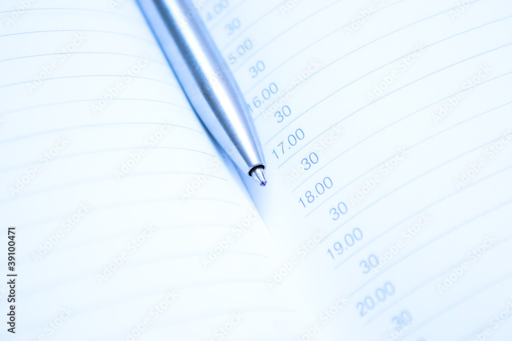 pen over note pad book