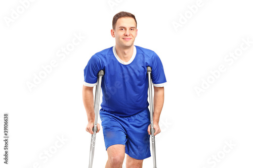 An injured soccer football player on crutches