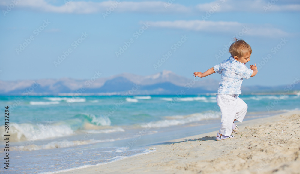 Young cute boy playing happily at pretty beach Young cute boy playing happily at pretty beach