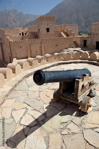 Old canon on the top of the Nakhl Fort, surrounded by the Hajar photo