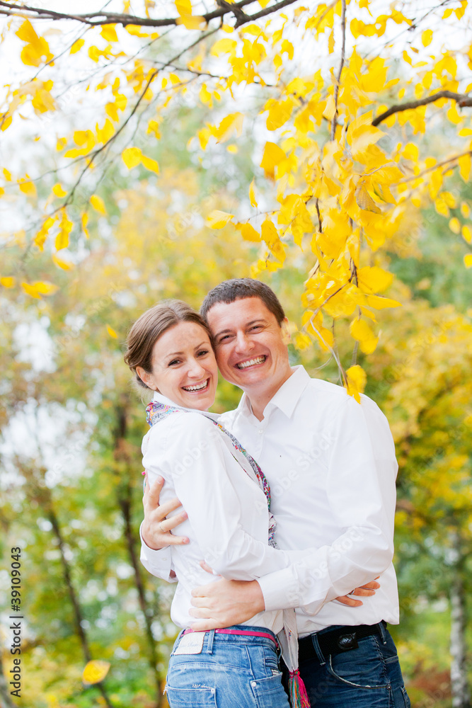 Romantic young beautiful couple on autumn walk
