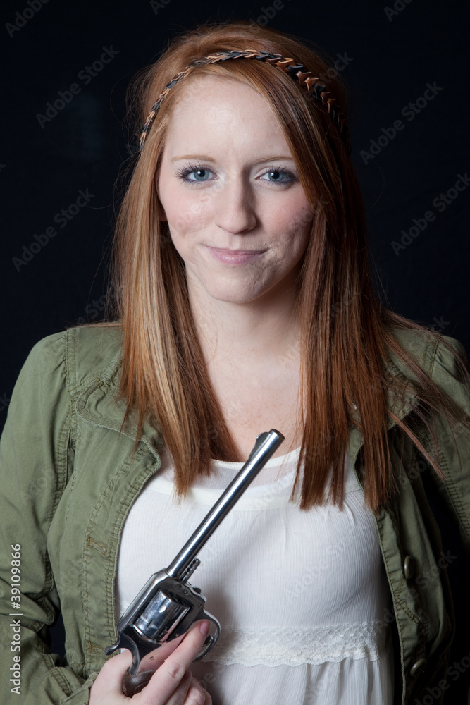 Fototapeta premium Girl holding a gun with a smirk