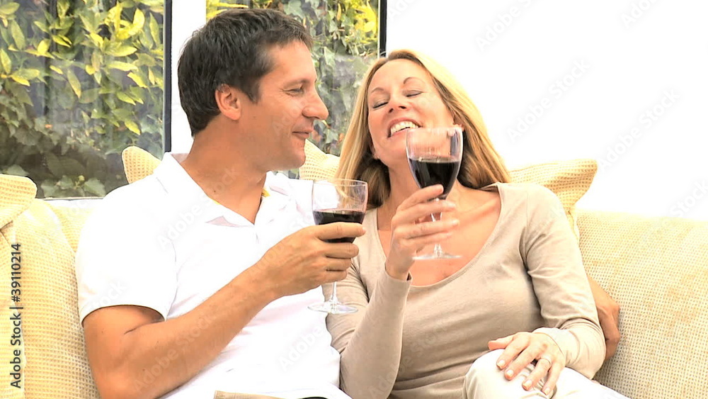 Attractive Couple Relaxing at Home Drinking Wine Attractive Couple Relaxing at Home Drinking Wine