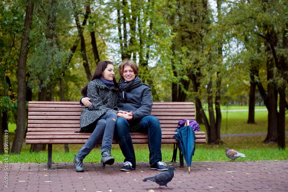 Fototapeta premium happy man and woman sitting in park