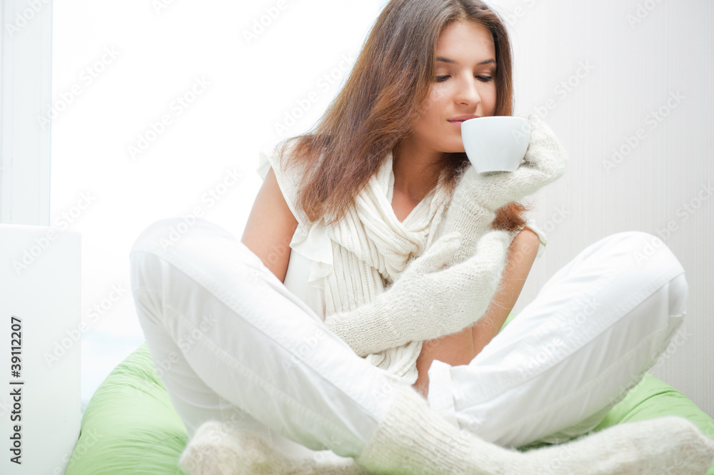 Portrait of a charming woman holding a cup of tea