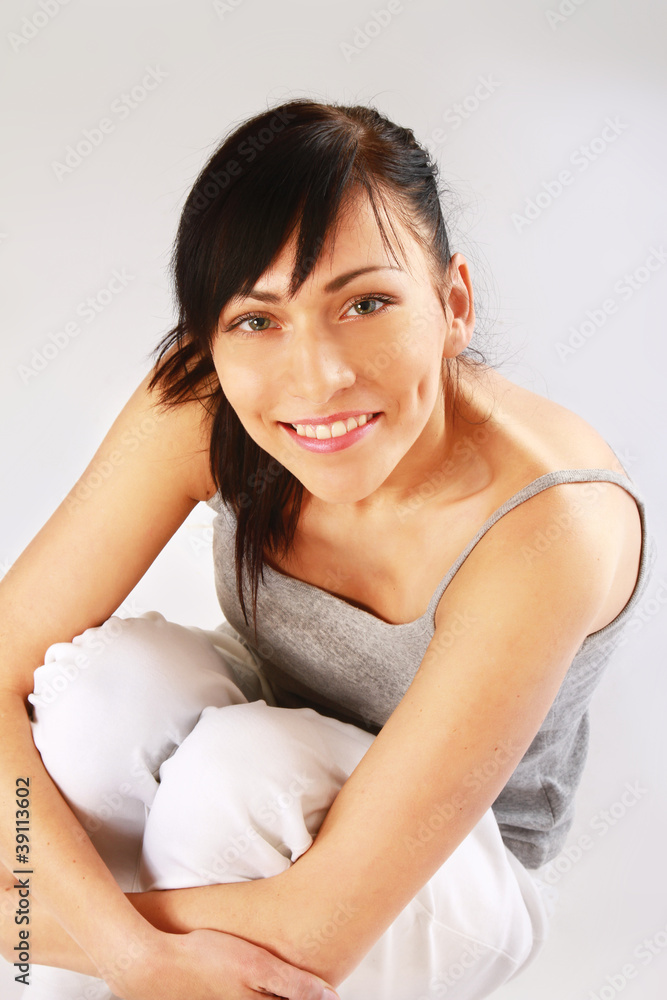A pretty young woman sitting on the floor A pretty young woman sitting on the floor