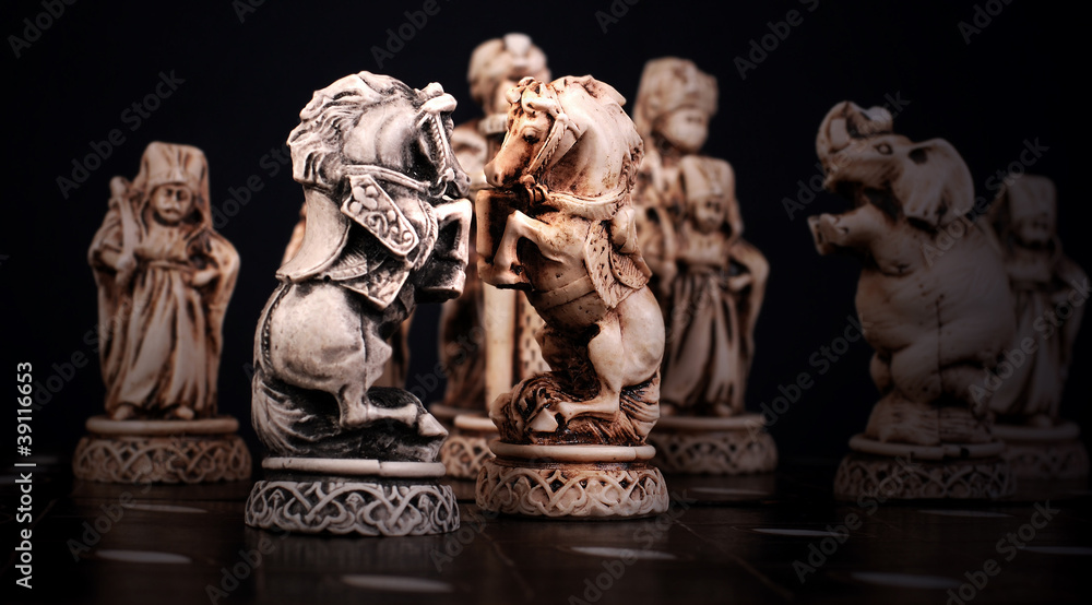 Fototapeta premium Chess pieces of horses stylized like mini sculptures