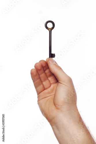 Man’s hand holding key over white background