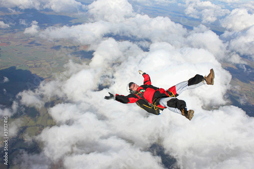 Skydiver falls through the air on his back