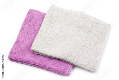 Towels and piece of soap isolated on white background