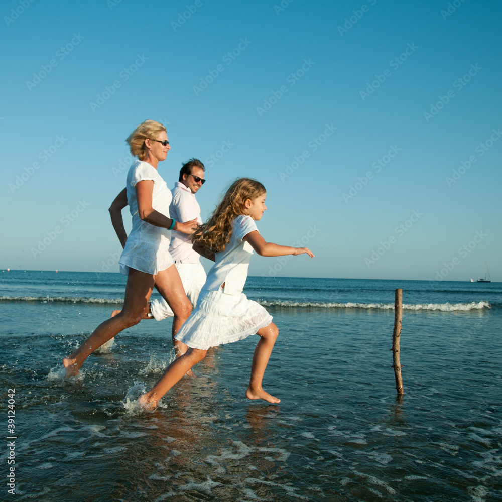 Happy summer vacation - family playing at the beach Happy summer vacation - family playing at the beach
