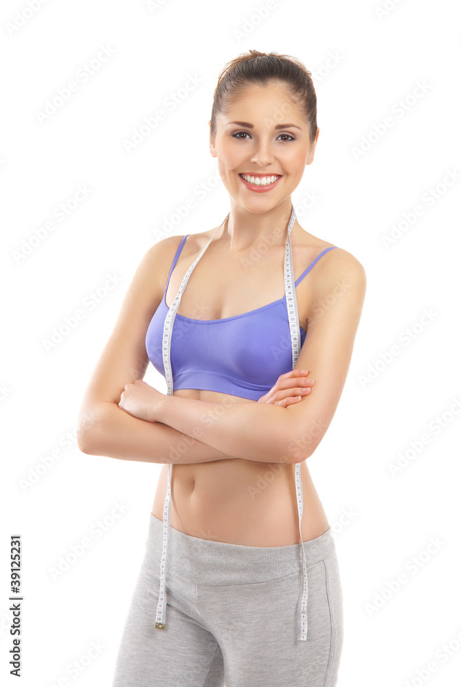 A young and fit brunette woman with a measuring tape A young and fit brunette woman with a measuring tape