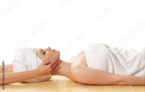 A young Caucasian woman laying on a spa pocedure