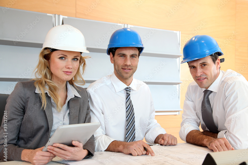Architects and businesswomen working on construction project Architects and businesswomen working on construction project