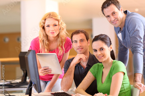 Group of smiling young people in training course