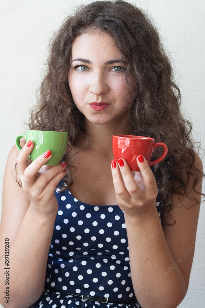 Young beautiful brunette holding two cups Young beautiful brunette holding two cups