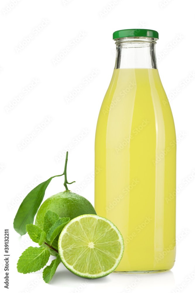Lime juice bottle, ripe limes and mint Lime juice bottle, ripe limes and mint