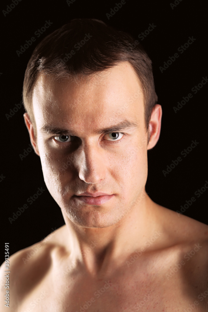 Portrait of a naked muscular man,isolated on black background Portrait of a naked muscular man,isolated on black background