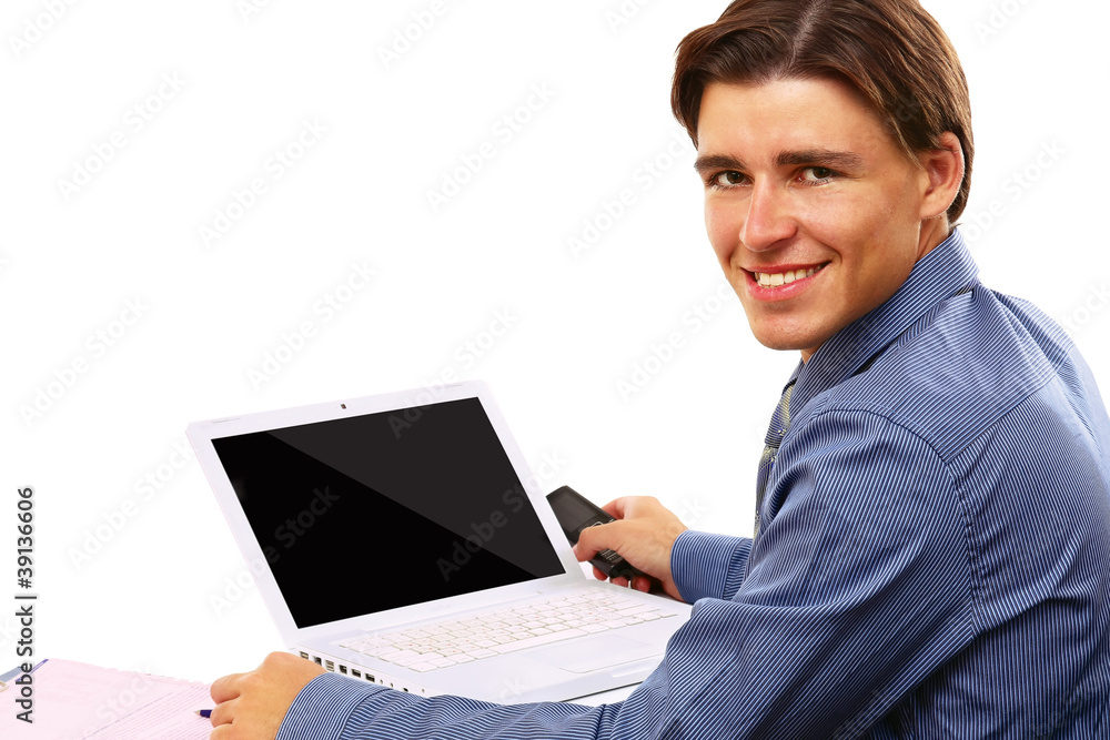 A young businessman in front of a laptop A young businessman in front of a laptop