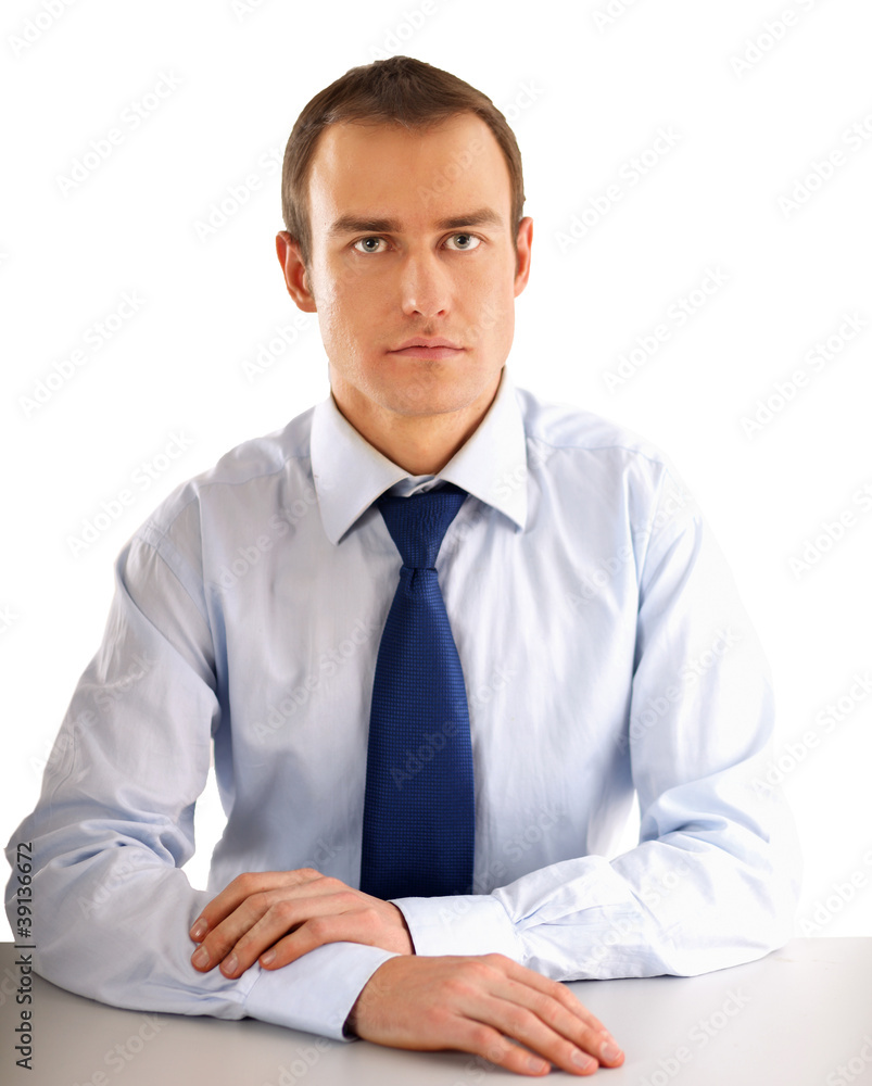 The businessman sitting on the desk in office The businessman sitting on the desk in office