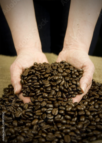 scooping coffee beans with hands