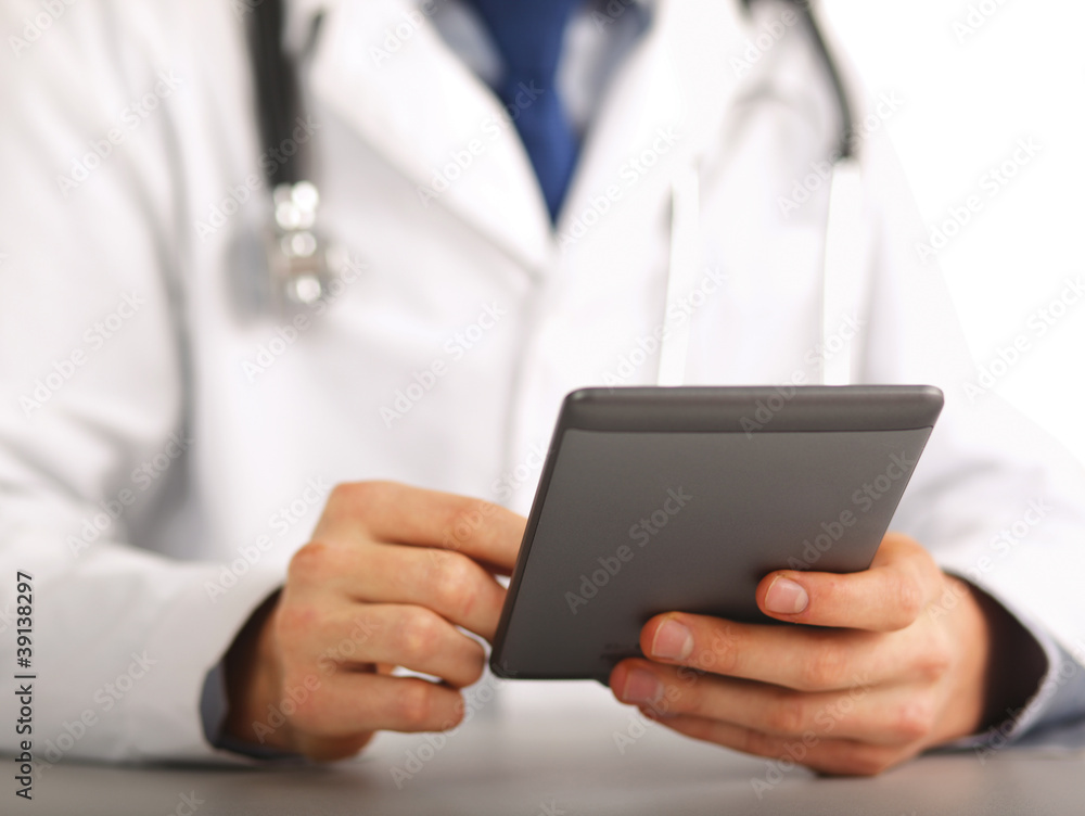 Handsome doctor using computer plane-table, focus on the hands Handsome doctor using computer plane-table, focus on the hands