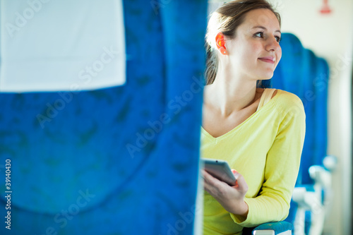 Young woman using her tablet computer in train © lightpoet