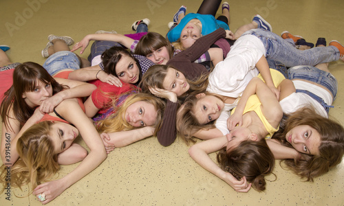 The big group of girls lies on a floor