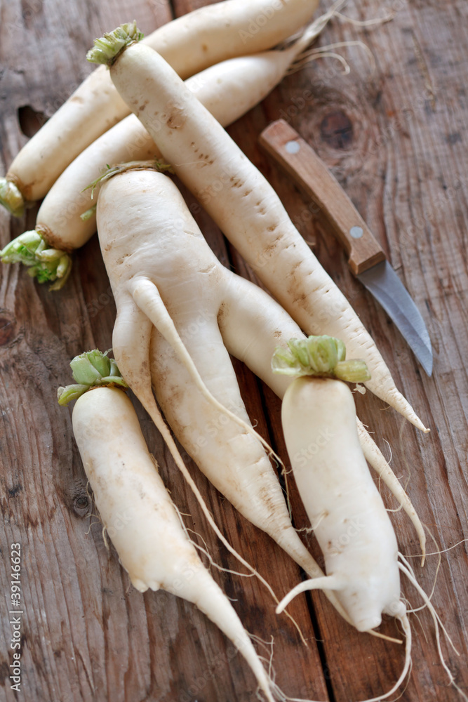 Daikon radish on the wood background Daikon radish on the wood background