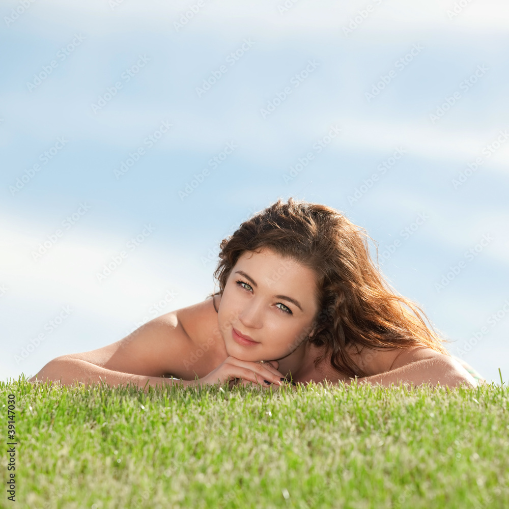young woman rest on the green grass young woman rest on the green grass