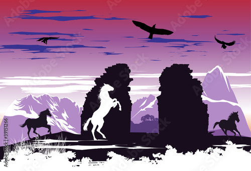 Black horses near the rocks at dawn