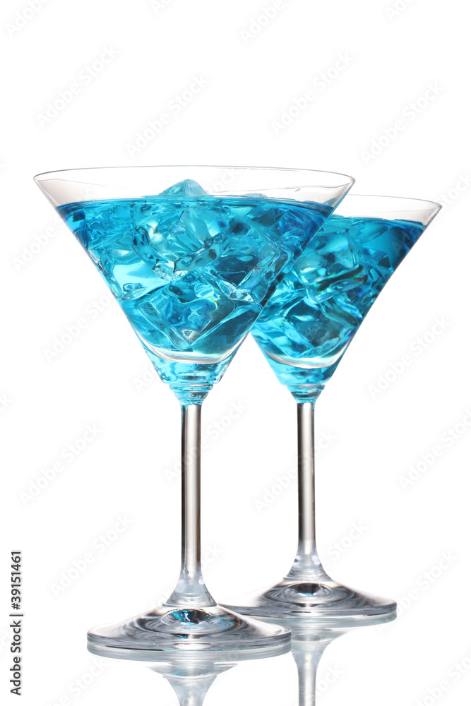 Blue cocktail in martini glasses with ice isolated on white