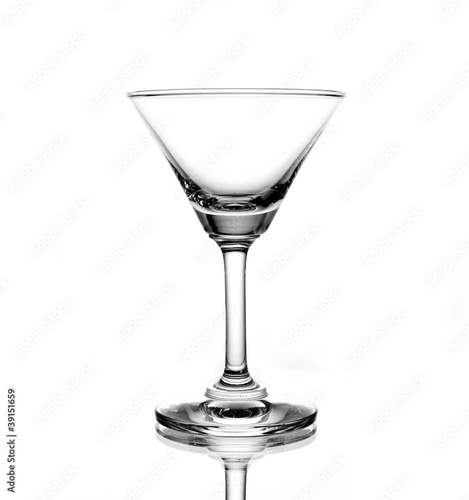 Empty glass of martini on white background sharp light and refl Empty glass of martini on white background sharp light and refl