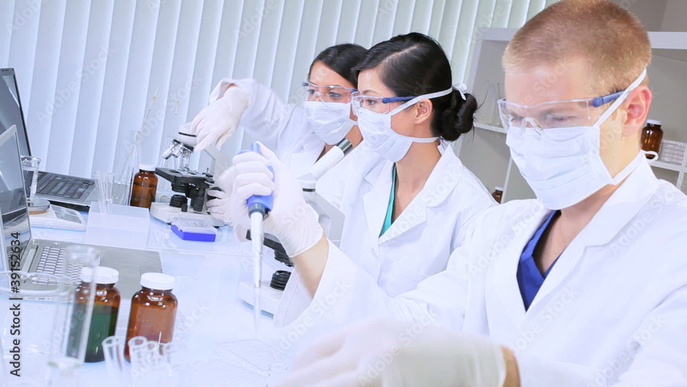Three Junior Doctors Studying in Hospital Laboratory Three Junior Doctors Studying in Hospital Laboratory