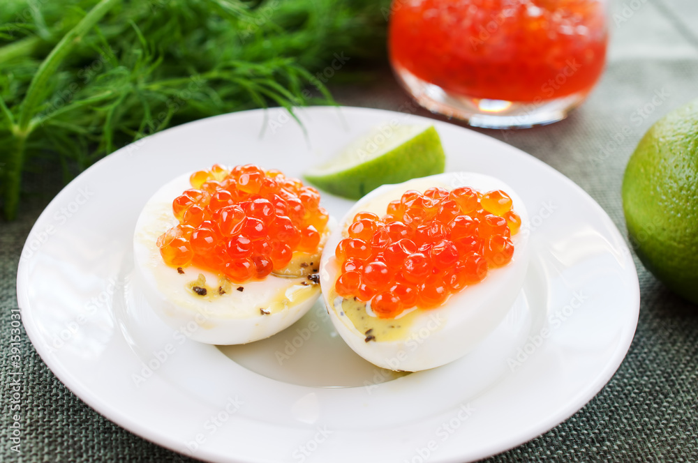 Eggs and caviar on white dish Eggs and caviar on white dish