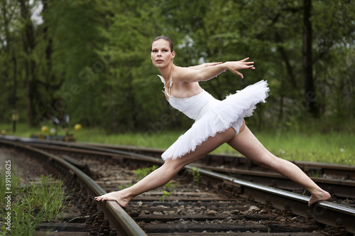 Young ballerina balancing on the rails © linkova